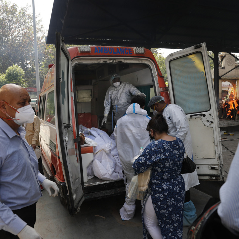 Health workers prepare to take out from an ambulance bodies of six people who died of COVID-19 for cremation, in New Delhi, India, Monday, April 19, 2021. New Delhi imposed a weeklong lockdown Monday night to prevent the collapse of the Indian capital's health system, which authorities said had been pushed to its limit amid an explosive surge in coronavirus cases. (AP Photo/Manish Swarup)