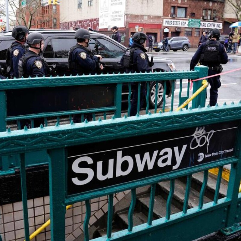 Members of the New York Police Department patrol the streets after at least 13 people were injured during a rush-hour shooting at a subway station in the New York borough of Brooklyn on April 12, 2022, where authorities said "several undetonated devices" were recovered amid chaotic scenes. - Ambulances lined the street outside the 36th Street subway station, where a New York police spokeswoman told AFP officers responded to a 911 call of a person shot at 8:27 am (1227 GMT). The suspect was still at large, according to Manhattan borough president Mark Levine. (Photo by TIMOTHY A. CLARY / AFP)