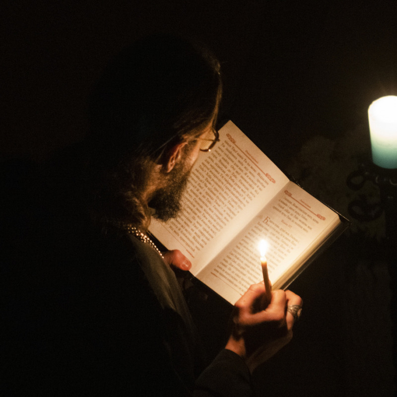 A priest delivers a religious service inside the Transfiguration of Jesus Orthodox Cathedral during blackout caused by recent Russian rocket attacks, in Kyiv, Ukraine, Saturday, Dec. 3, 2022. A top Orthodox priest in Ukraine's capital says he supports the efforts of President Volodymyr Zelenskyy's government and counter-intelligence agency to end Russian spying and meddling in Ukrainian politics through a Moscow-affiliated church. (AP Photo/Efrem Lukatsky)