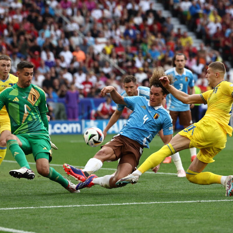 epa11439766 Artem Dovbyk of Ukraine (R) in action against Wout Faes (C) and goalkeeper Koen Casteels (L) of Belgium during the UEFA EURO 2024 Group E soccer match between Ukraine and Belgium, in Stuttgart, Germany, 26 June 2024. EPA/ANNA SZILAGYI