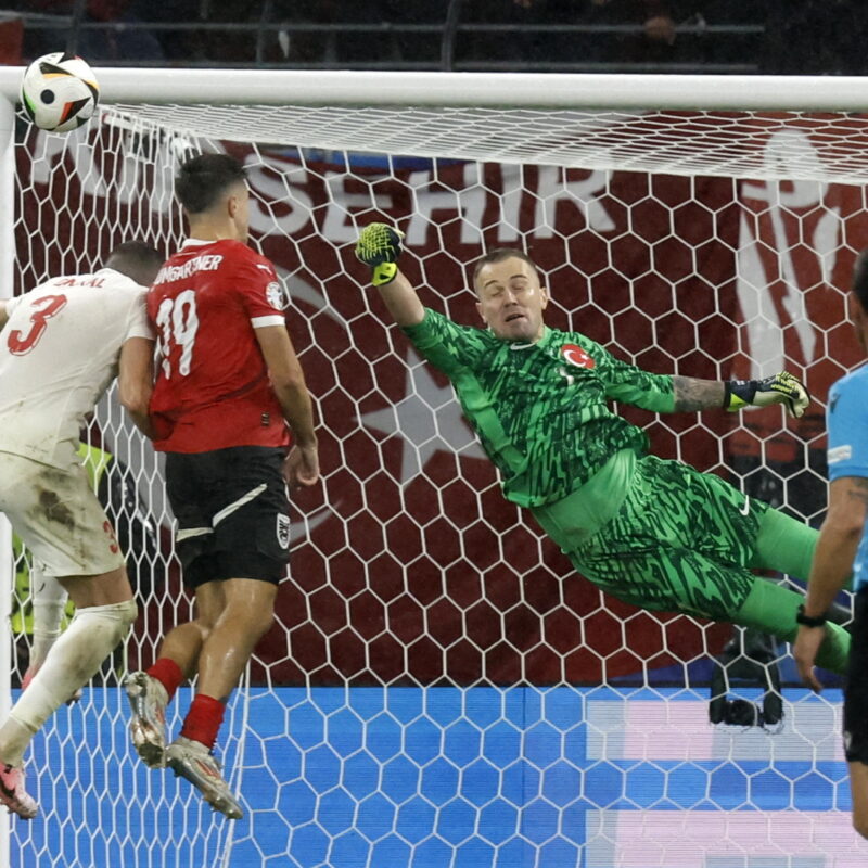 epa11453749 Christoph Baumgartner of Austria (C) in action against Merih Demiral (L) and goalkeeper Mert Gunok (R) of Turkey during the UEFA EURO 2024 Round of 16 soccer match between Austria and Turkey, in Leipzig, Germany, 02 July 2024. EPA/ROBERT GHEMENT