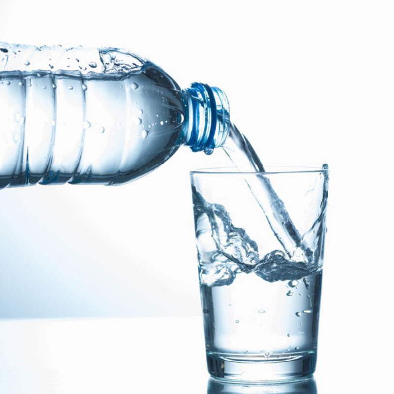 Pouring water from bottle into glass high quality and high resolution studio shoot