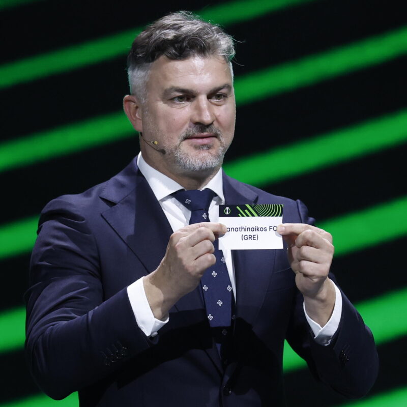 epa11573322 Michael Zewlakow shows a ticket of Panathinaïkos FC during the UEFA Europa Conference League league phase draw 2024/25, in Monaco, 30 August 2024. EPA/SEBASTIEN NOGIER