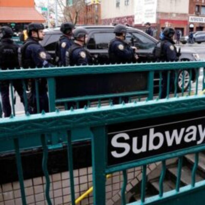 Members of the New York Police Department patrol the streets after at least 13 people were injured during a rush-hour shooting at a subway station in the New York borough of Brooklyn on April 12, 2022, where authorities said "several undetonated devices" were recovered amid chaotic scenes. - Ambulances lined the street outside the 36th Street subway station, where a New York police spokeswoman told AFP officers responded to a 911 call of a person shot at 8:27 am (1227 GMT). The suspect was still at large, according to Manhattan borough president Mark Levine. (Photo by TIMOTHY A. CLARY / AFP)