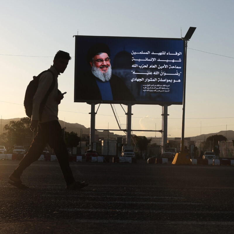 epa11662916 A person walks past a digital billboard showing Lebanon's Hezbollah late leader Hassan Nasrallah in Sana'a, Yemen, 16 October 2024. Nasrallah was killed in an Israeli strike on Beirut on 27 September. EPA/YAHYA ARHAB