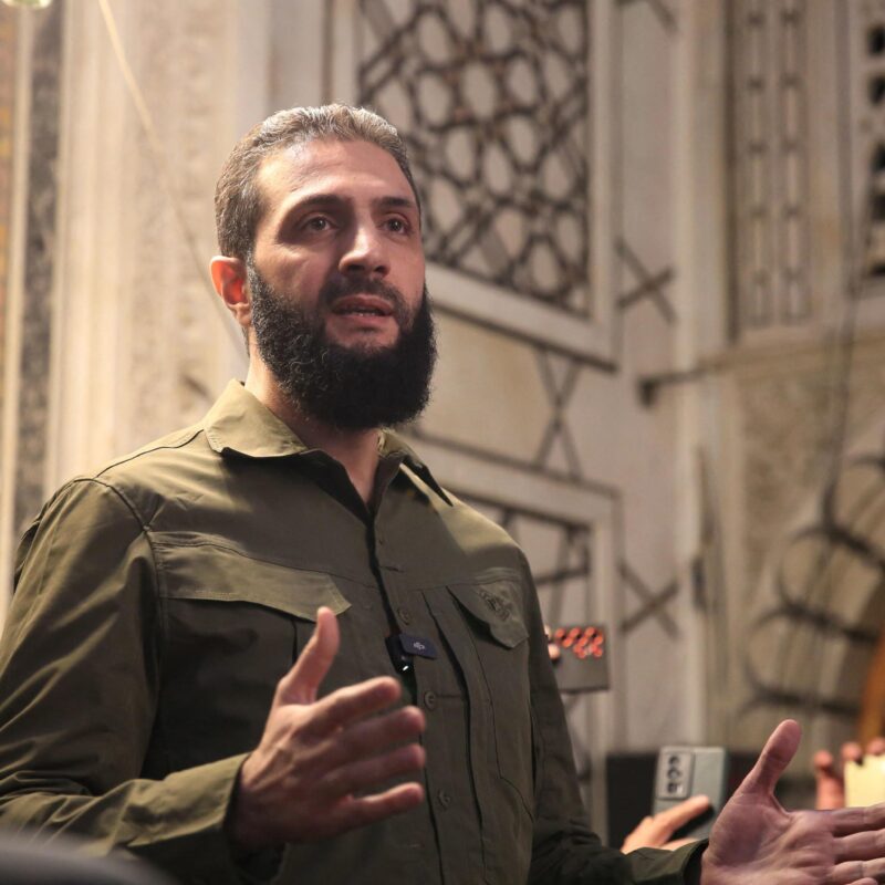 TOPSHOT - The leader of Syria's Islamist Hayat Tahrir al-Sham (HTS) group that headed a lightning rebel offensive snatching Damascus from government control, Abu Mohammed al-Jolani, address a crowd at the capital's landmark Umayyad Mosque on December 8, 2024. Jolani, now using his real name Ahmed al-Sharaa, gave a speech as the crowd chanted "Allahu akbar (God is greatest)," a video shared by the rebels on their Telegram channel showed. (Photo by Aref TAMMAWI / AFP)