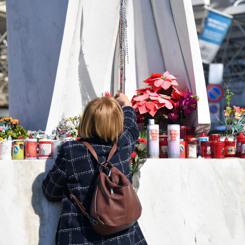 Flowers and candles are laid at the foot of a statue of Pope St. John Paul II outside the Gemelli University Hospital, where Pope Francis is hospitalized for tests and treatment for bronchitis, in Rome, Italy, 21 February 2025. Pope Francis was hospitalized on 14 February due to a respiratory tract infection.ANSA/FABIO CIMAGLIA