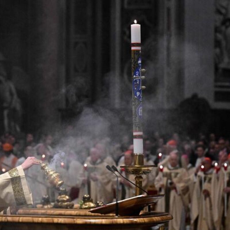 A celebrant swings a censer near the Easter candle during the Easter vigil as part of the Holy Week celebrations, at St Peter's basilica in the Vatican on April 19, 2025. (Photo by Tiziana FABI / AFP)