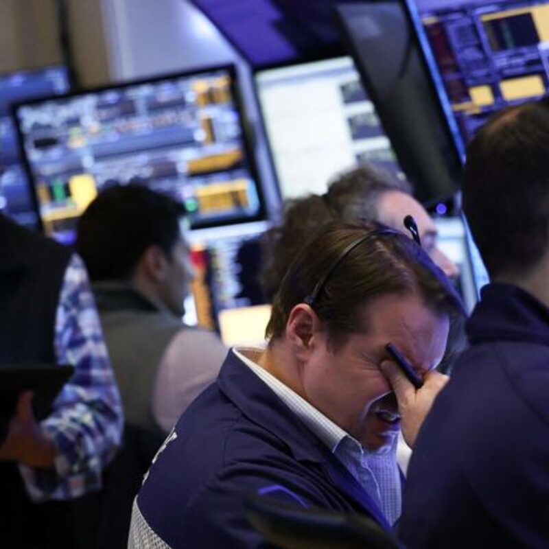 Traders work on the floor of the New York Stock Exchange (NYSE) at the opening bell in New York City, on April 3, 2025. Wall Street stocks sank in early trading on April 3,2025, joining a global equity selloff after President Donald Trump's latest tariff announcement exacerbated worries about a trade war and global economic downturn. (Photo by CHARLY TRIBALLEAU / AFP)