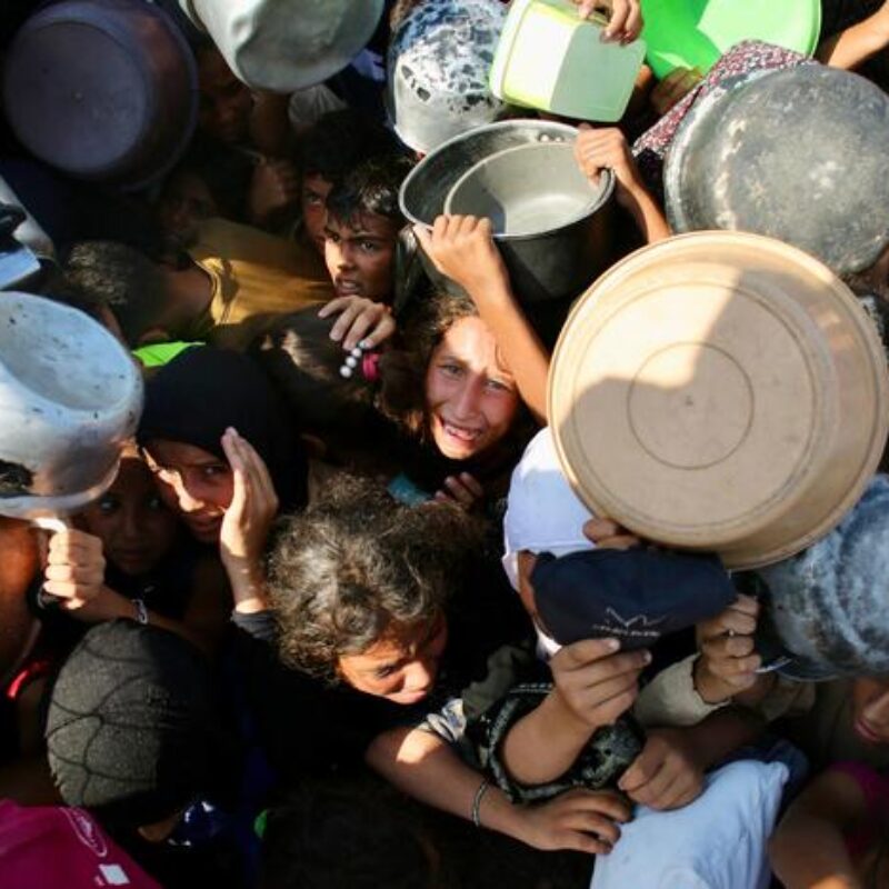 Palestinian children shove to receive a meal at a charity kitchen in the Mawasi area of Khan Yunis in the southern Gaza Strip on July 22, 2025. The head of Gaza's largest hospital said 21 children have died due to malnutrition and starvation in the Palestinian territory in the past three days, amid a devastating assault by Israeli forces. (Photo by AFP)