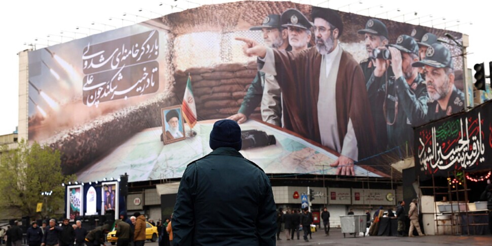 https://assets.gazzettadelsud.it/2026/03/An-Iranian-security-member-stands-guard-in-front-of-a-billboard-showing-Iranian-Supreme-Leader-Mojtaba-Khamenei-and-Iranian-military-commanders-during-a-rally-to-mark-International-Quds-Day-in-Tehran-970x485-1773414410.jpg